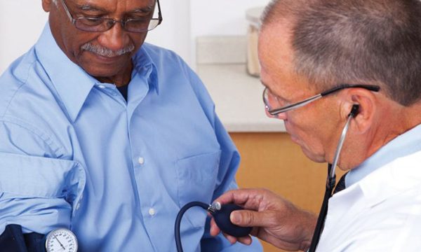 Male patient receiving blood pressure test