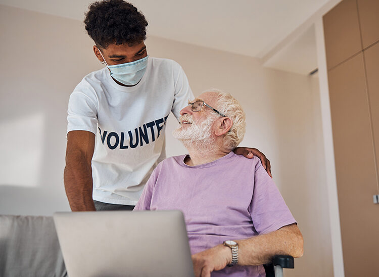 A young male volunteer with an elderly senior client.